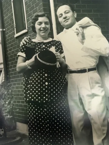 Vintage 1950s couple in formal attire holding a hat, representing early foodservice wholesale and distribution industry professionals.